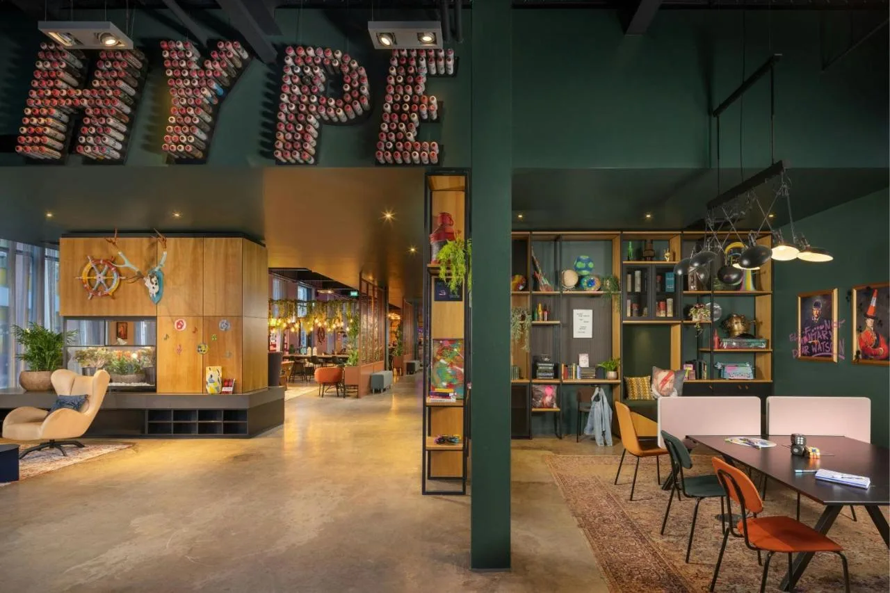 a large room with a table and chairs in it at Moxy Glasgow Merchant City in Glasgow